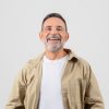 Senior man with a joyful laugh, looking upwards, isolated on a white background, gives off an uplifting and positive vibe